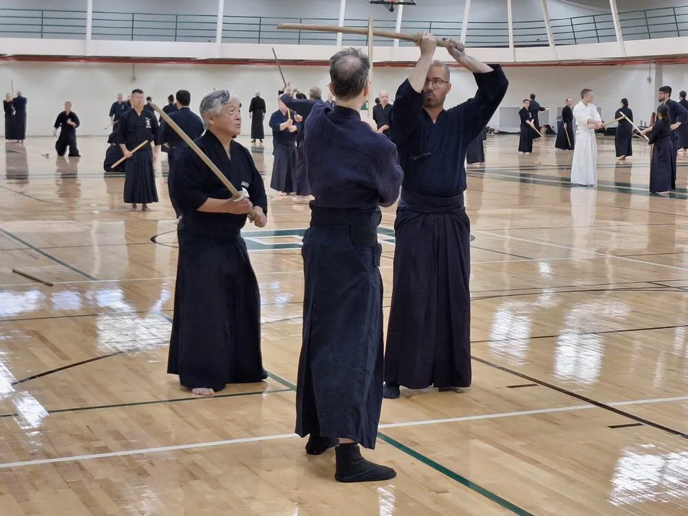 An instructor demonstrating jo technique to seminar participants